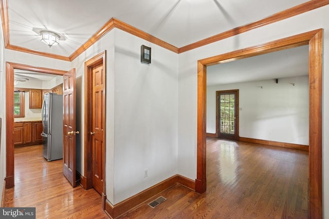  - hallway featuring light wood-style floors and crown molding