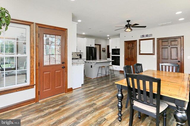  - dining space featuring wood finished floors, ceiling fan, and recessed lighting