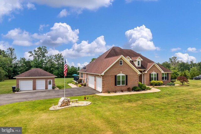  - traditional home featuring brick siding, a front yard, and a garage