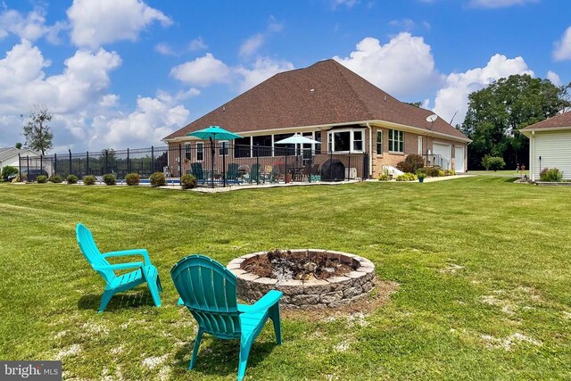  - rear view of house with a garage, brick siding, and a fire pit