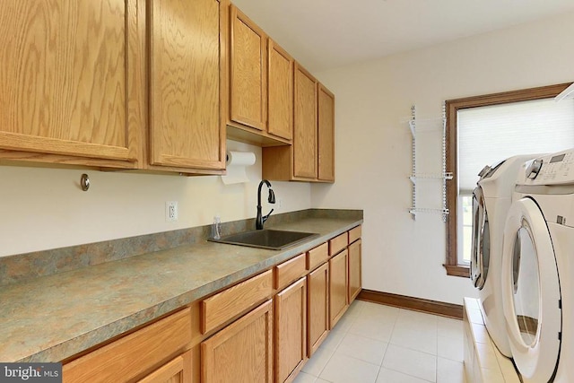  - laundry room featuring washer and clothes dryer, cabinet space, and light tile patterned floors