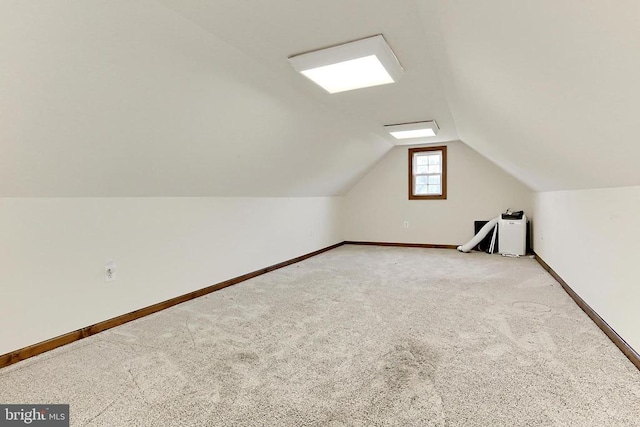  - additional living space featuring lofted ceiling and carpet flooring