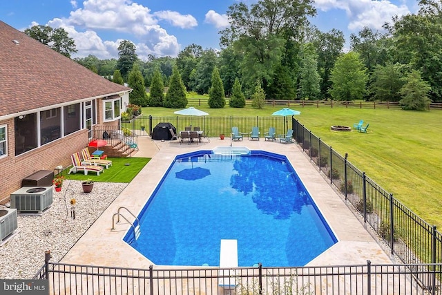  - view of swimming pool featuring a patio, a fenced backyard, a diving board, and a fire pit