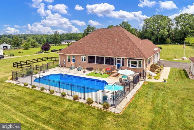  - view of swimming pool featuring a patio and view of scattered trees