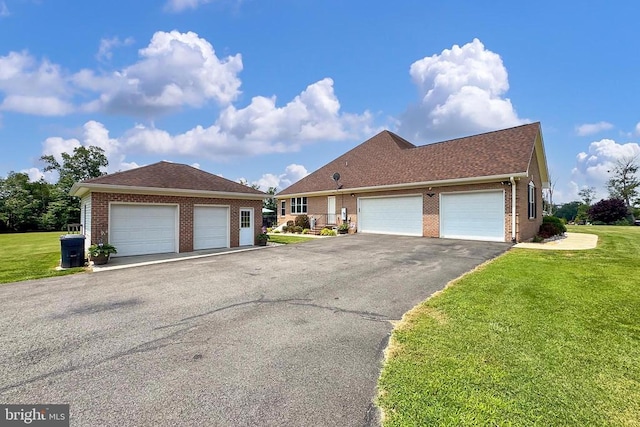  - view of front facade featuring brick siding, a front lawn, and a shingled roof