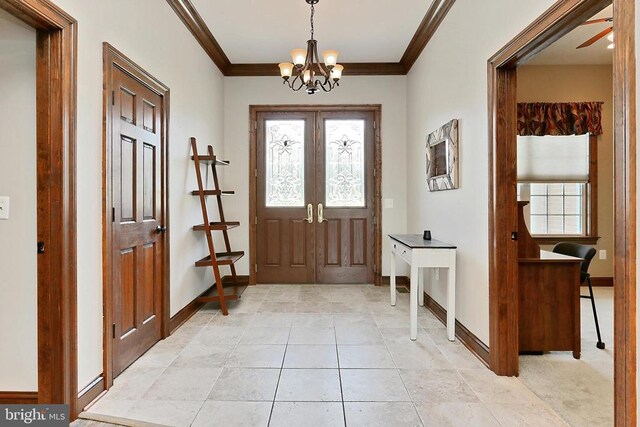  - entryway featuring a chandelier, crown molding, and light tile patterned flooring
