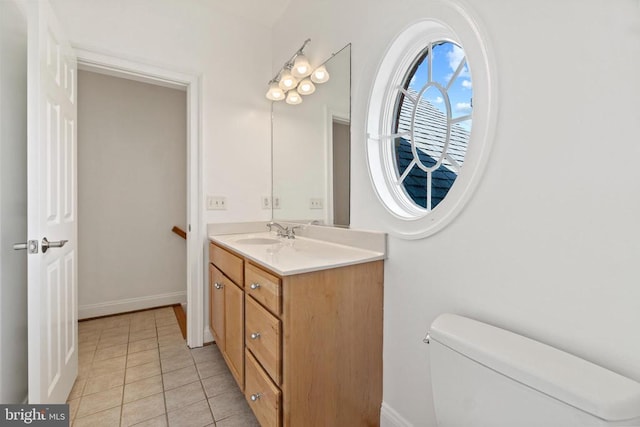 bathroom featuring vanity, toilet, and tile patterned flooring