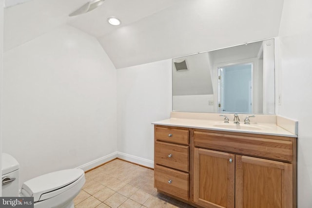 bathroom featuring lofted ceiling, toilet, tile patterned floors, vanity, and baseboards