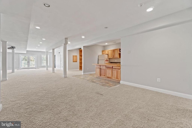 unfurnished living room featuring light carpet, recessed lighting, and baseboards
