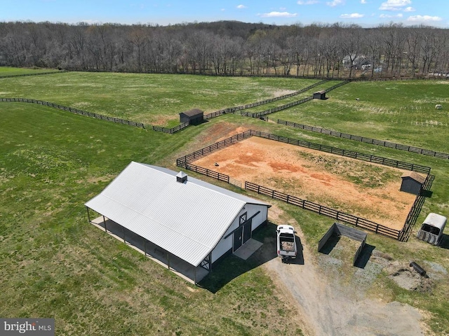 aerial view of sparsely populated area featuring agricultural land and a forest