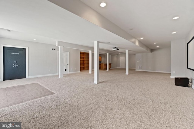 finished below grade area with baseboards, carpet flooring, and recessed lighting