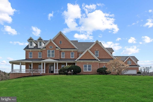 view of front of house with brick siding, a porch, and a front yard