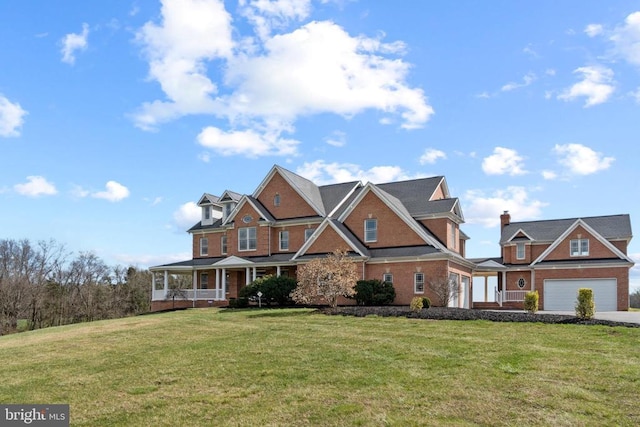 view of front of house featuring a porch, a front yard, and an attached garage