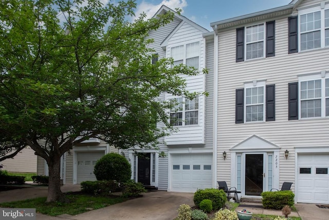 7207 Finch Ln, Fredericksburg, VA 22407 - townhome / multi-family property featuring concrete driveway, an attached garage, and entry steps