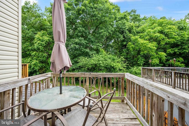 7207 Finch Ln, Fredericksburg, VA 22407 - wooden deck featuring outdoor dining area and view of scattered trees
