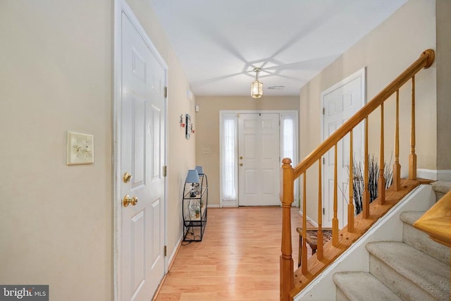 7207 Finch Ln, Fredericksburg, VA 22407 - entrance foyer with light wood-type flooring, stairway, and baseboards