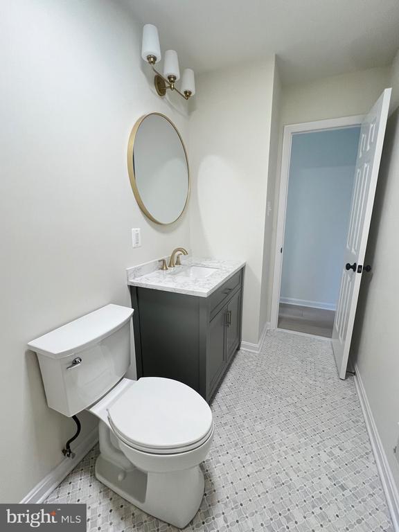 377 Cleveland St, Warrenton, VA 20186 - bathroom with vanity, toilet, and baseboards