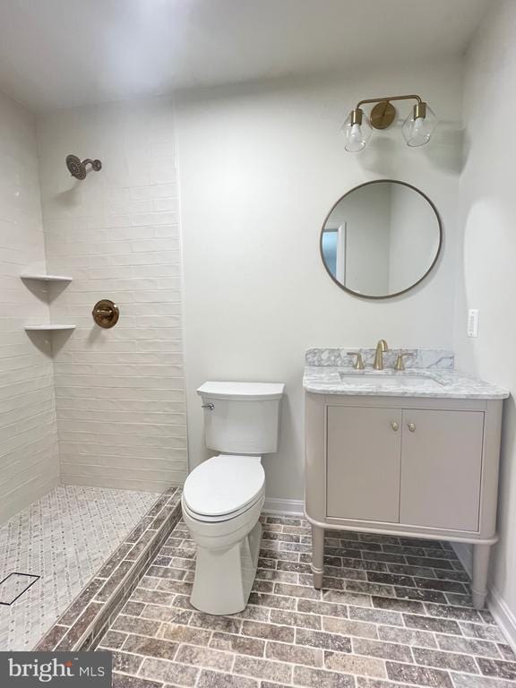 377 Cleveland St, Warrenton, VA 20186 - full bathroom with brick patterned flooring, baseboards, a tile shower, and toilet