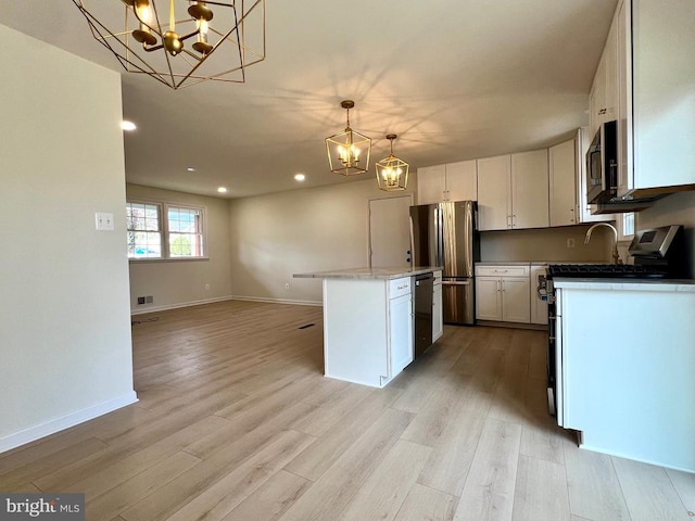 377 Cleveland St, Warrenton, VA 20186 - kitchen featuring a chandelier, appliances with stainless steel finishes, recessed lighting, white cabinets, and light wood-style floors