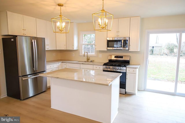 377 Cleveland St, Warrenton, VA 20186 - kitchen featuring stainless steel appliances, a chandelier, a sink, light wood finished floors, and a center island