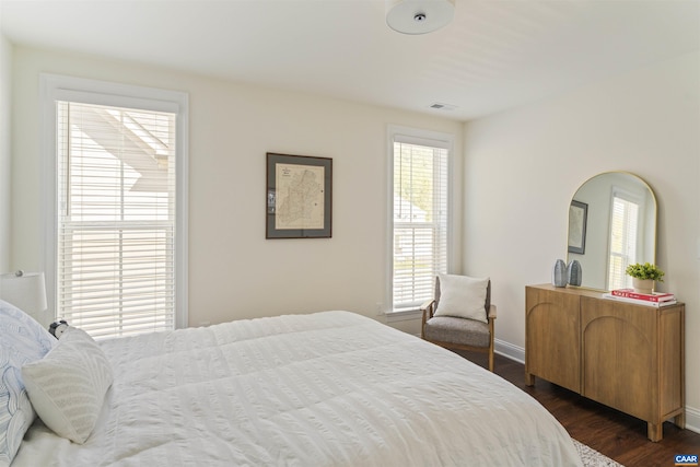 4017 Marie Curie Ct, Charlottesville, VA 22902 - bedroom with multiple windows, dark wood finished floors, and baseboards