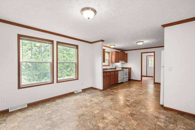 4767 Ox Rd S, Edinburg, VA 22824 - kitchen featuring stone finish flooring, crown molding, range, brown cabinets, and a textured ceiling