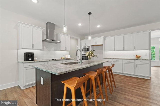 465 Glenmore Ln Lot 30, Keswick, VA 22947 - kitchen with wall chimney exhaust hood, stainless steel appliances, a sink, recessed lighting, and white cabinetry