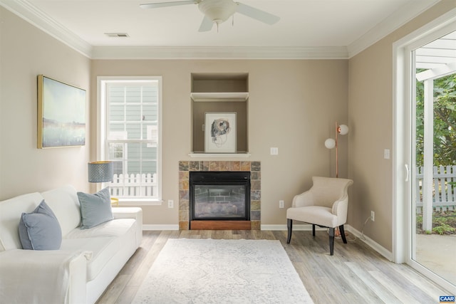 1875 Clay Dr, Crozet, VA 22932 - living area featuring a tile fireplace, light wood finished floors, ceiling fan, and ornamental molding