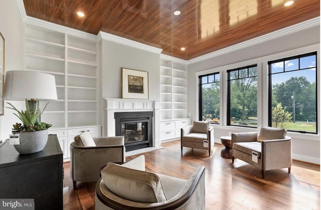 interior space featuring crown molding, built in features, wooden ceiling, and a healthy amount of sunlight