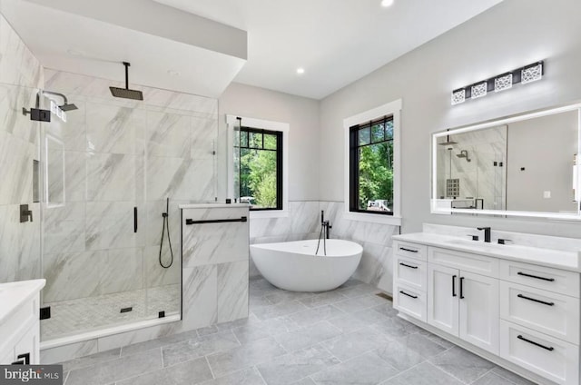 bathroom featuring vanity, independent shower and bath, and tile walls