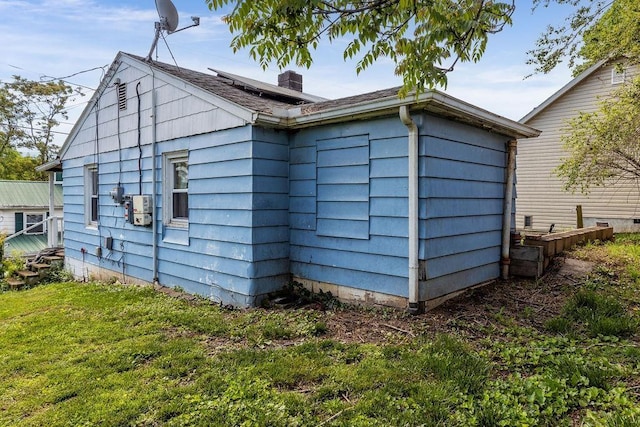 267 Shiloh Ave, Waynesboro, VA 22980 - view of side of property with roof mounted solar panels, a lawn, and a chimney