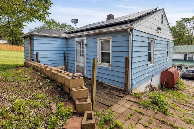267 Shiloh Ave, Waynesboro, VA 22980 - rear view of property with heating fuel, roof mounted solar panels, and a chimney