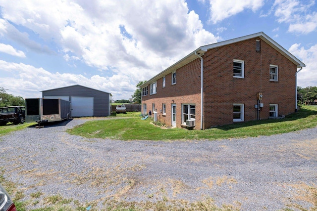 5226 Dogwood Dr, Mount Jackson, VA 22842 - view of home's exterior with a detached garage, an outbuilding, brick siding, and a lawn