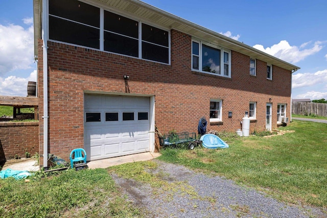 5226 Dogwood Dr, Mount Jackson, VA 22842 - view of property exterior featuring dirt driveway, an attached garage, brick siding, and a yard