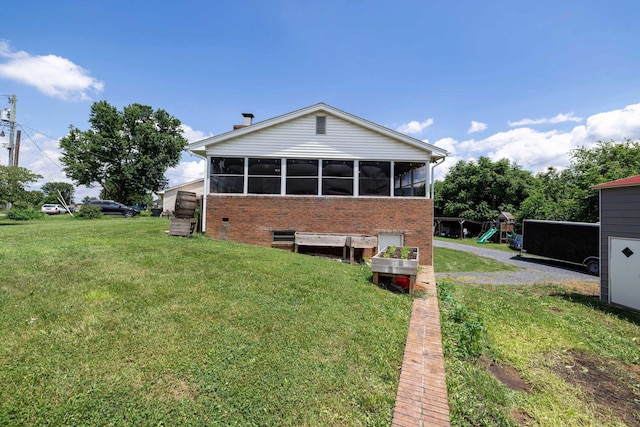 5226 Dogwood Dr, Mount Jackson, VA 22842 - rear view of property featuring a playground, brick siding, a sunroom, and a yard
