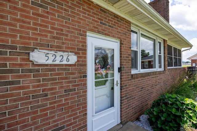 5226 Dogwood Dr, Mount Jackson, VA 22842 - view of exterior entry with a chimney and brick siding