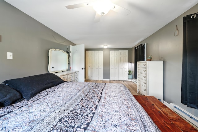 5226 Dogwood Dr, Mount Jackson, VA 22842 - bedroom featuring a baseboard heating unit, multiple closets, light wood finished floors, and ceiling fan