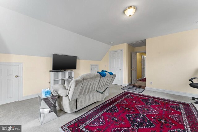 living room featuring light carpet and vaulted ceiling