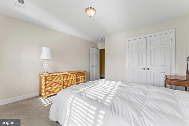 bedroom with carpet floors and a closet