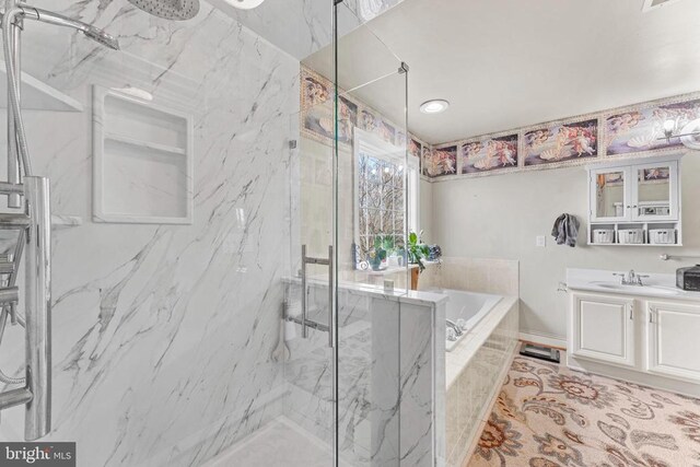 bathroom featuring shower with separate bathtub and vanity