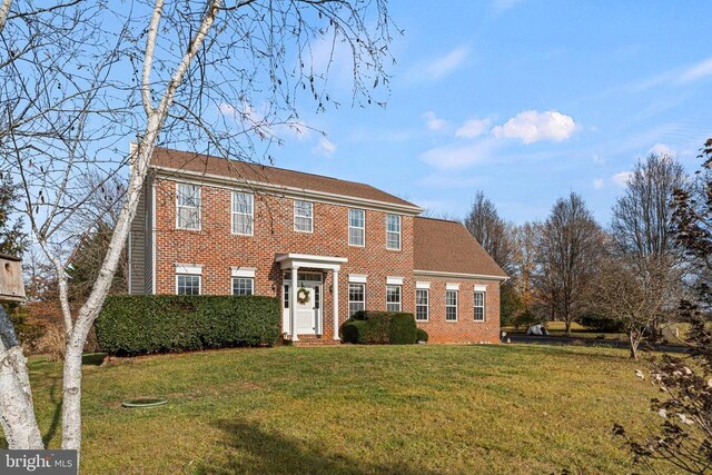 colonial-style house with a front yard