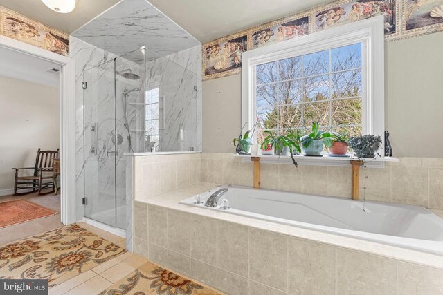 bathroom featuring tile patterned floors and plus walk in shower