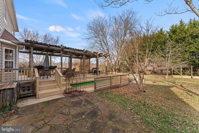 view of yard with a pergola, a patio area, and a swimming pool side deck