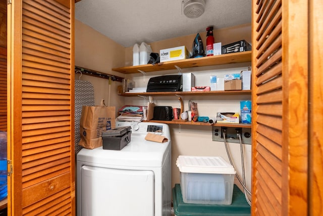 storage area featuring washer / clothes dryer and a sink