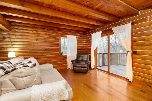 living room with beamed ceiling, a healthy amount of sunlight, wooden ceiling, and wood finished floors