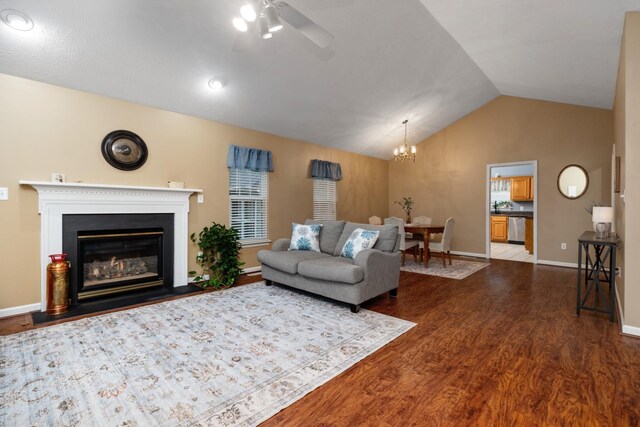 88 Ashleigh Dr, Waynesboro, VA 22980 - living room featuring dark wood-style flooring, vaulted ceiling, a ceiling fan, baseboards, and a chandelier