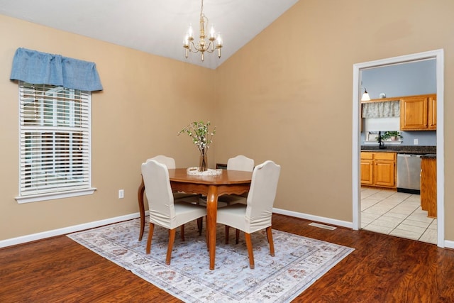 88 Ashleigh Dr, Waynesboro, VA 22980 - dining area with a chandelier, light wood-style flooring, vaulted ceiling, and baseboards