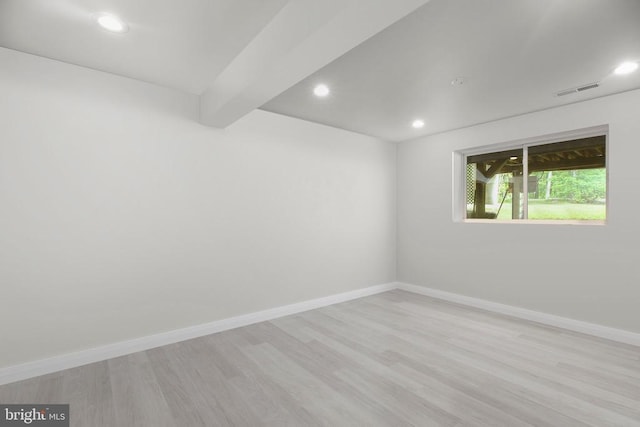  - empty room featuring light wood-style flooring, recessed lighting, baseboards, and beamed ceiling