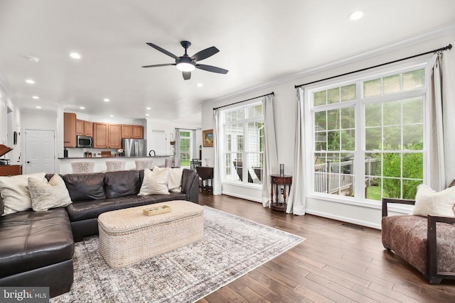  - living area featuring ornamental molding, ceiling fan, recessed lighting, dark wood-style floors, and baseboards