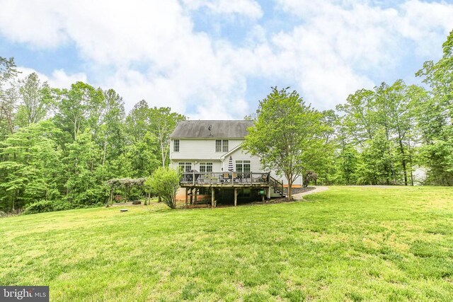  - rear view of property with a deck and a lawn